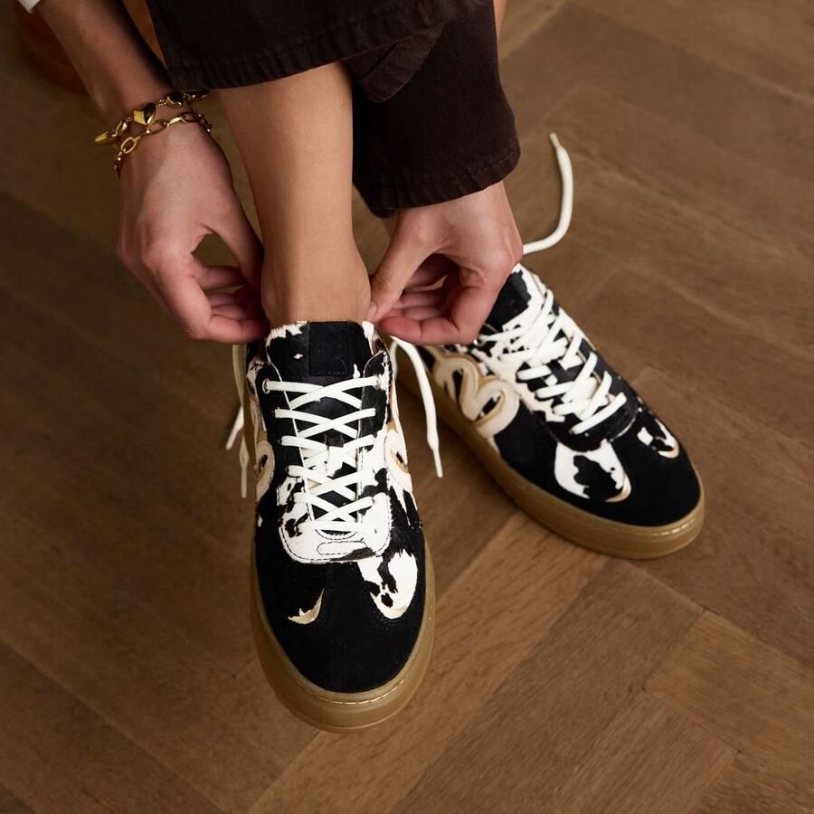 Manfield Dames Zwarte cow print sneakers met pony hair