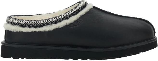 UGG Zwarte leren muilezels met reliëflogo